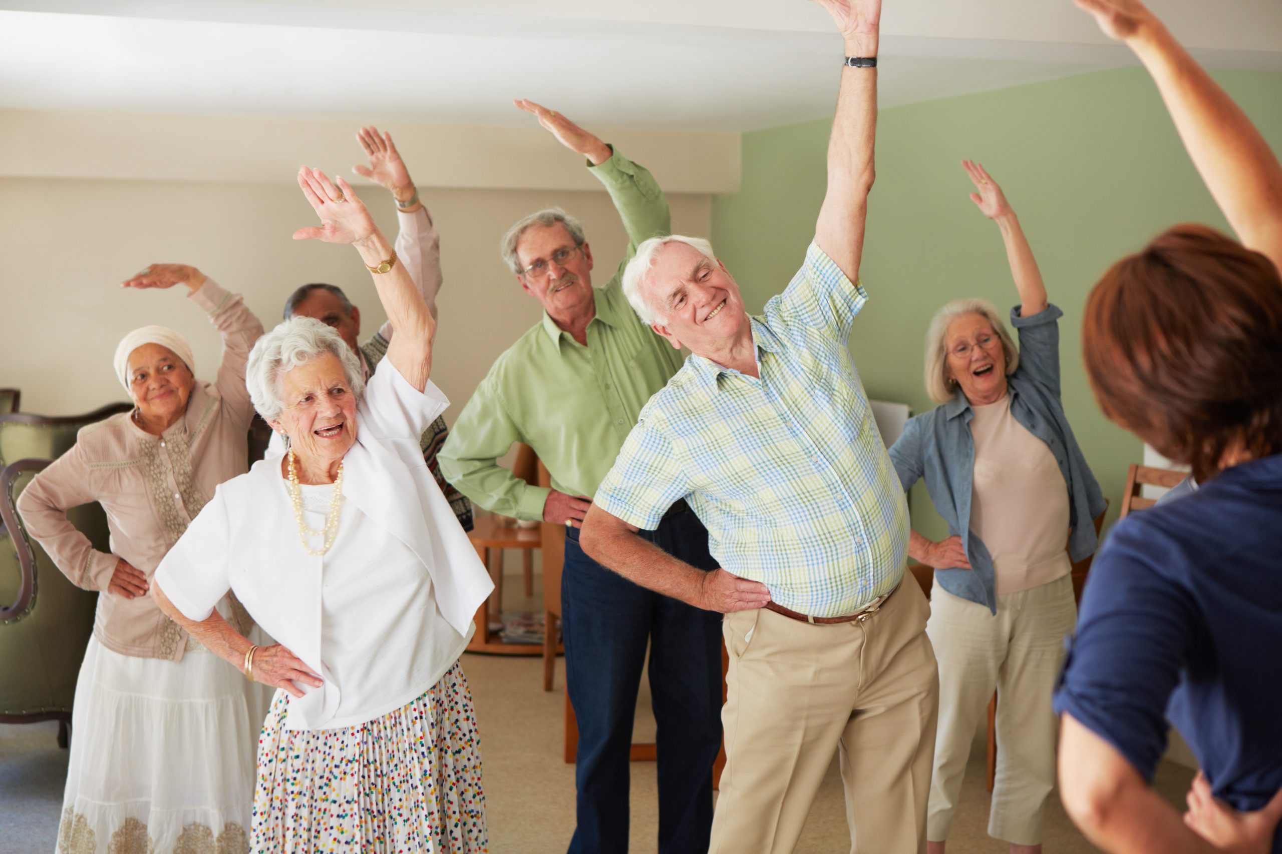 Group of older people doing gentle exercises