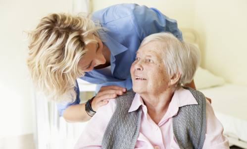 Female nurse talking to an elderly woman