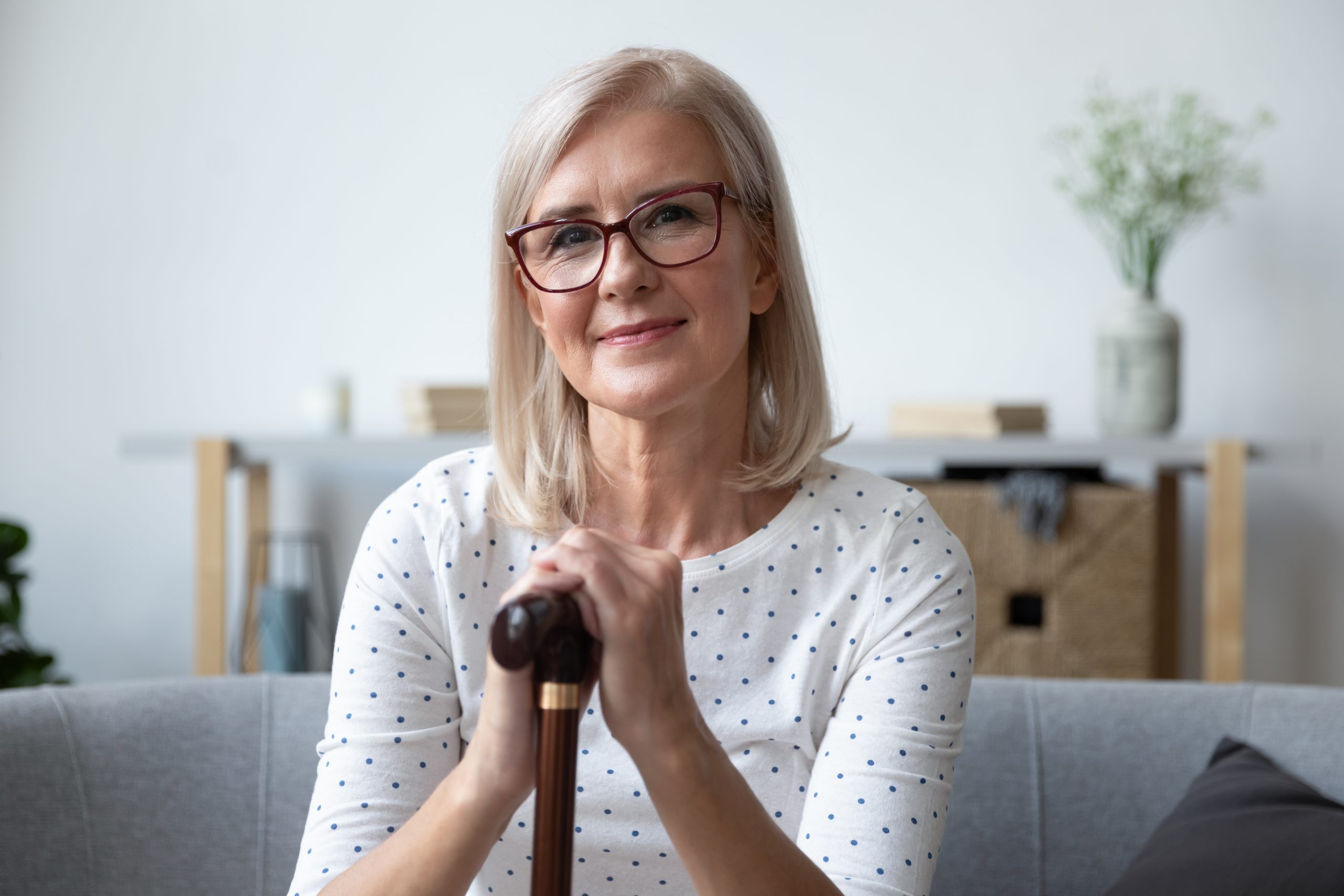 Head shot portrait beautiful older woman in glasses with cane
