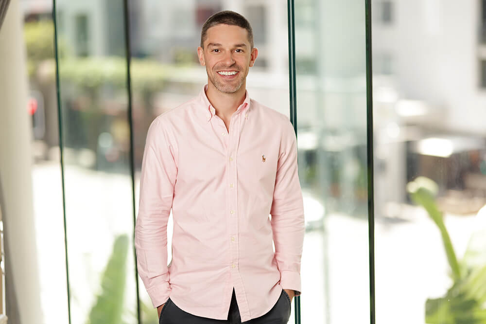 Image of General Manager Quality, Risk and Workforce Capability, Richard Fox, smiling at the camera with his hands in his pocket