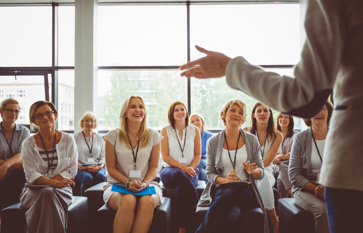 A group of people sitting and listening to a speaker